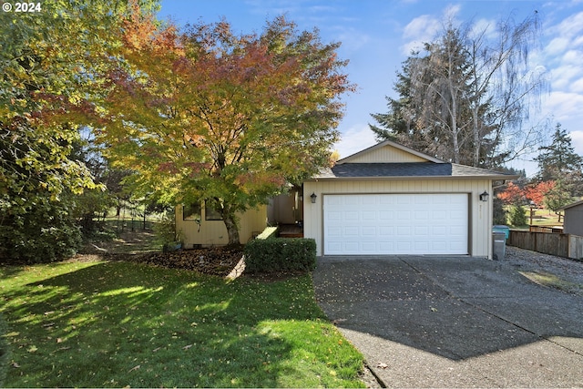 view of front of home with a garage and a front lawn