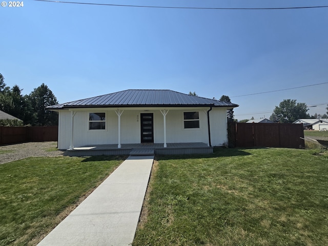 view of front of home with a front yard and covered porch