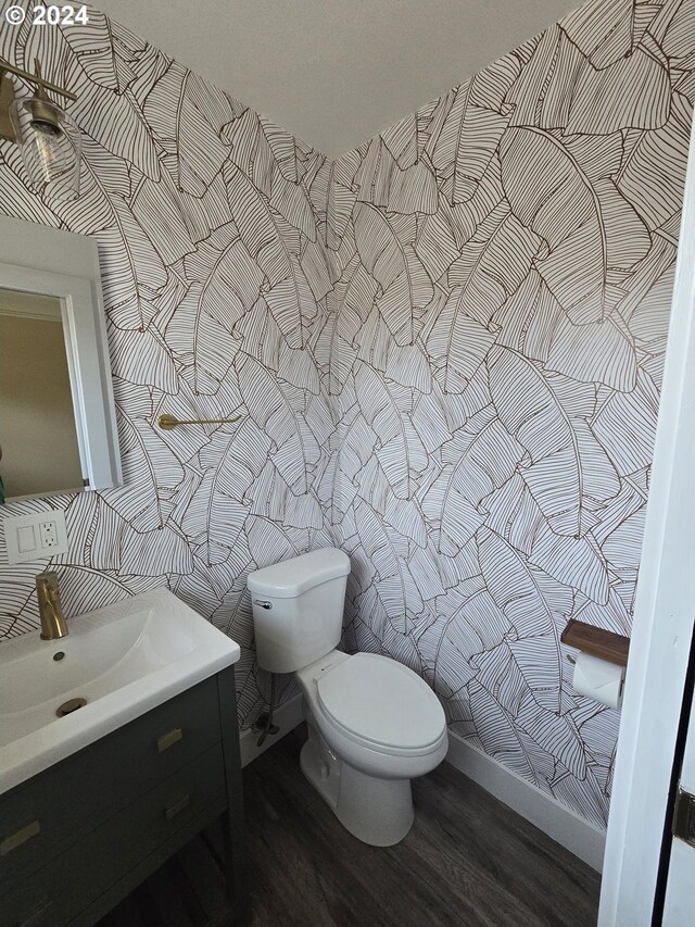 bathroom featuring vanity, hardwood / wood-style floors, and toilet