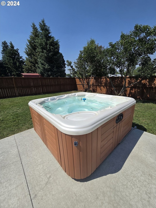 view of swimming pool with a hot tub