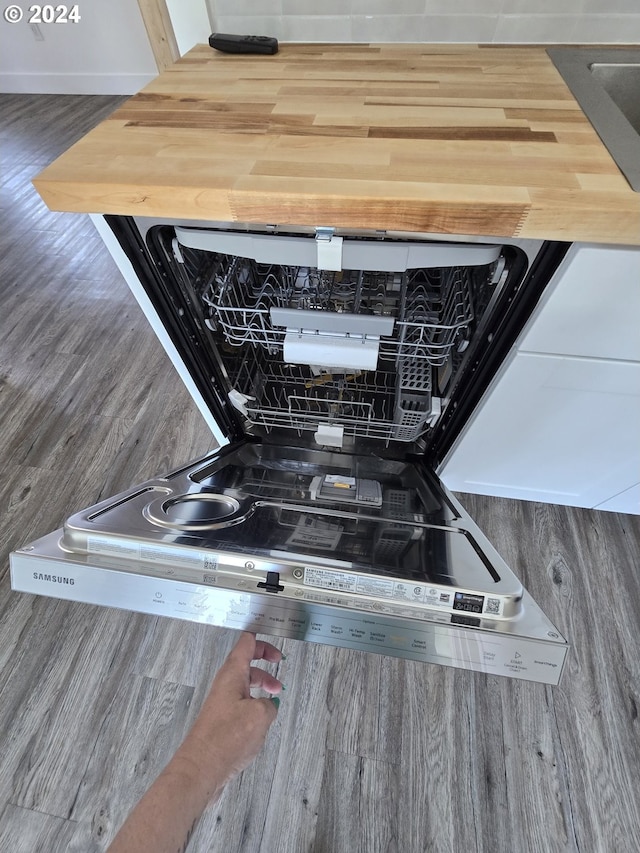 room details featuring hardwood / wood-style flooring and dishwasher