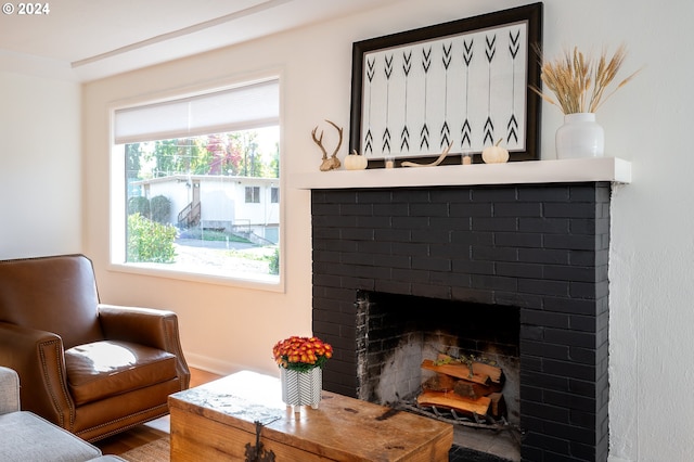 sitting room with a fireplace and hardwood / wood-style floors