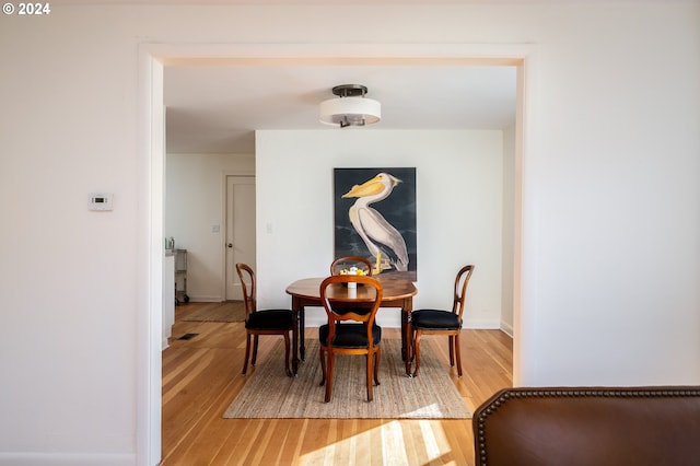 dining space with hardwood / wood-style flooring