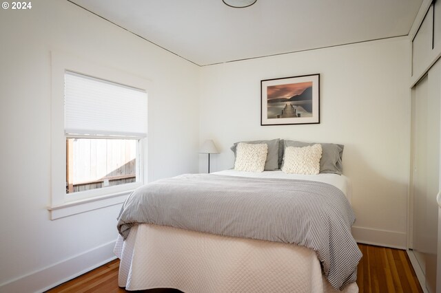 bedroom featuring dark wood-type flooring