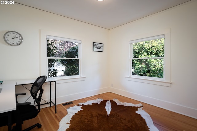 office space with wood-type flooring