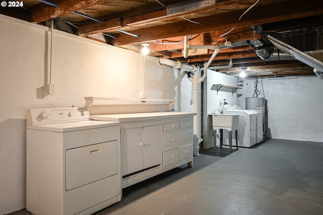 clothes washing area featuring electric water heater and washing machine and dryer