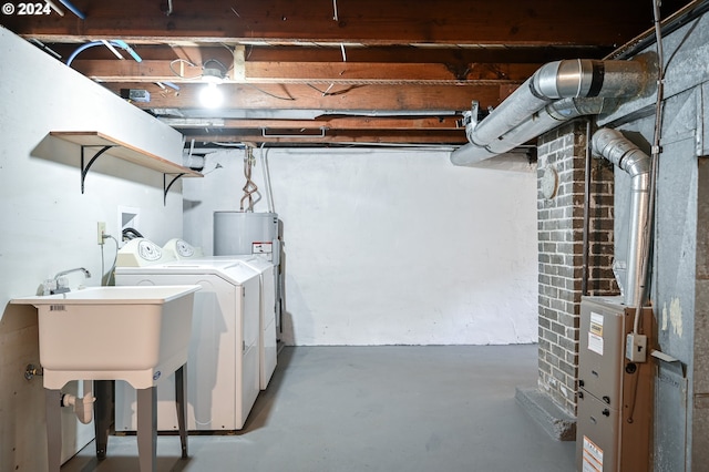 washroom featuring water heater and independent washer and dryer