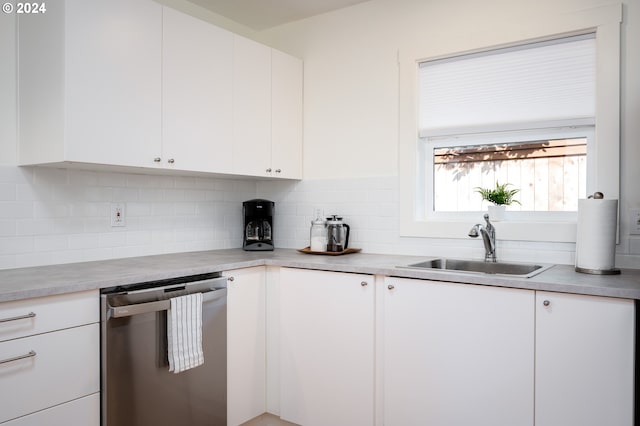 kitchen featuring white cabinets, sink, tasteful backsplash, and stainless steel dishwasher