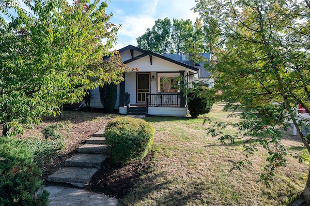 view of front of home with covered porch and a front yard