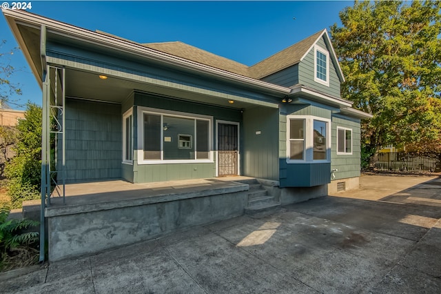 view of front of property featuring a porch and a patio area