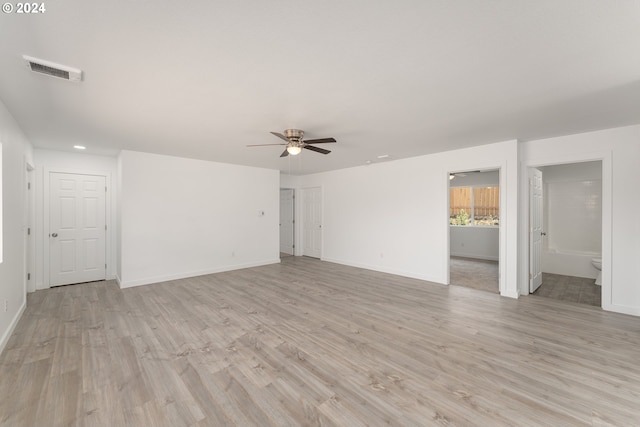 spare room featuring light hardwood / wood-style floors and ceiling fan