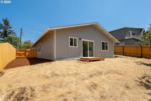 back of house with a wooden deck