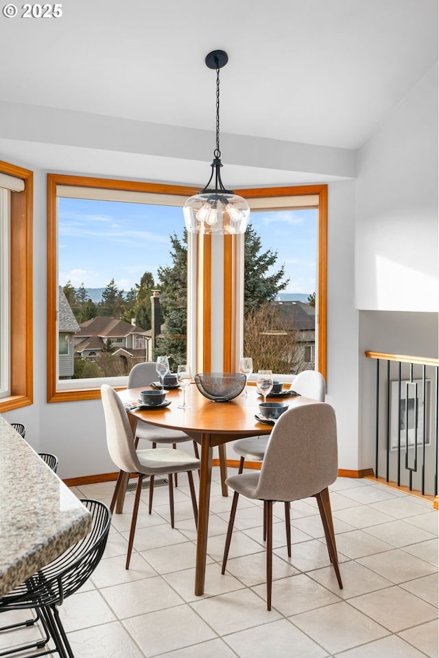 dining space featuring light tile patterned flooring