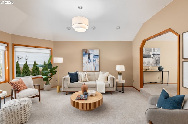 carpeted living room featuring vaulted ceiling