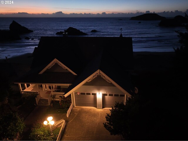 birds eye view of property featuring a beach view and a water view