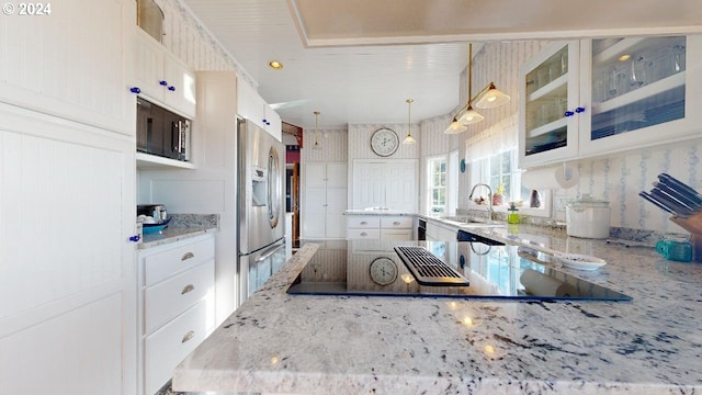 1545 Beach Ave, Brookings, OR 97415 - kitchen featuring hanging light fixtures, light stone counters, white cabinets, stainless steel fridge, and sink
