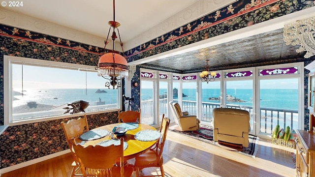 1545 Beach Ave, Brookings, OR 97415 - dining area with a water view, an inviting chandelier, and wood-type flooring