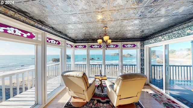 1545 Beach Ave, Brookings, OR 97415 - sunroom featuring a water view, an inviting chandelier, and a beach view