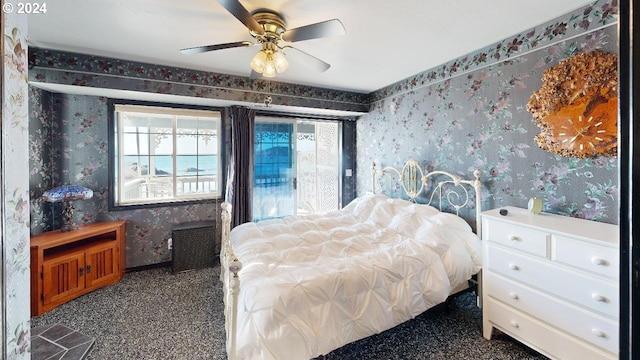 1545 Beach Ave, Brookings, OR 97415 - bedroom featuring access to exterior, dark carpet, a water view, and ceiling fan