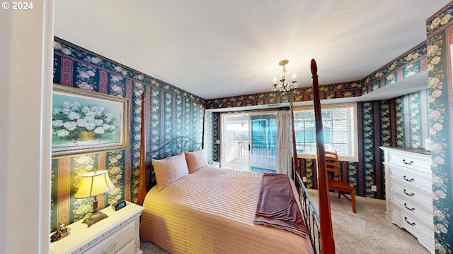 1545 Beach Ave, Brookings, OR 97415 - bedroom with a notable chandelier, access to outside, and light colored carpet