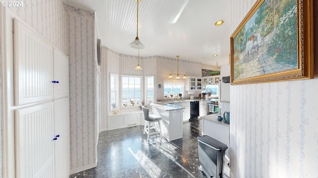 1545 Beach Ave, Brookings, OR 97415 - kitchen featuring stainless steel range oven, black dishwasher, decorative light fixtures, a breakfast bar, and white cabinetry