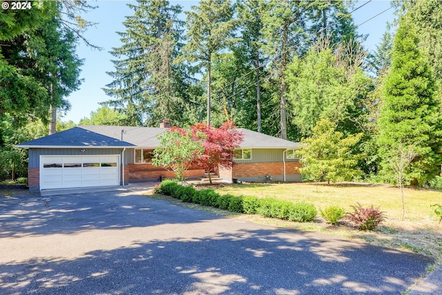 view of front of house with a garage and a front lawn