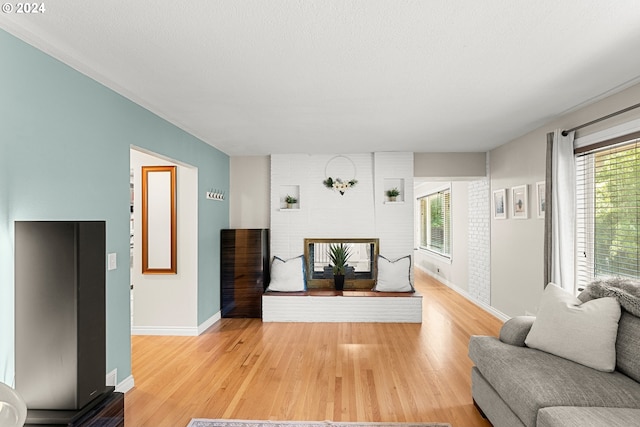 living room with hardwood / wood-style flooring and a textured ceiling