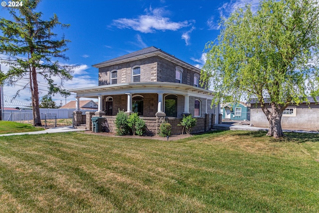 view of front of home featuring covered porch and a front yard