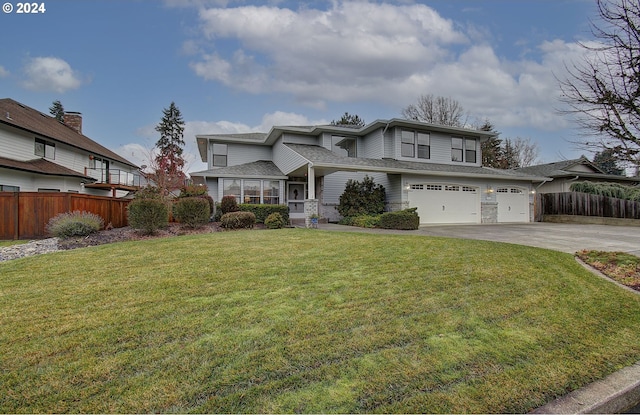 view of front of home featuring a front lawn and a garage