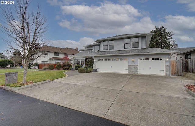 view of front of house with a front lawn and a garage