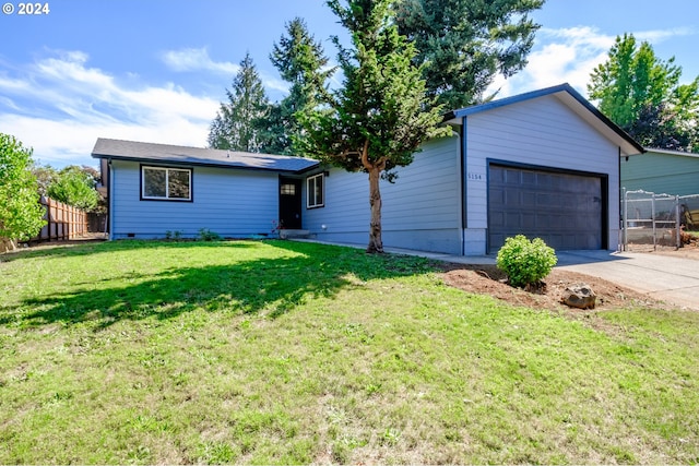 ranch-style home with a garage and a front lawn