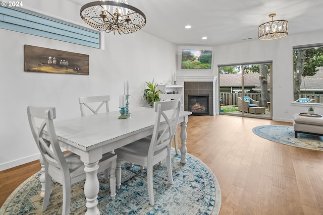 dining space featuring a fireplace and hardwood / wood-style floors