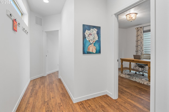 corridor featuring hardwood / wood-style floors