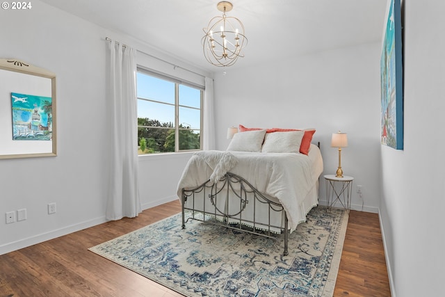 bedroom featuring a chandelier and wood-type flooring