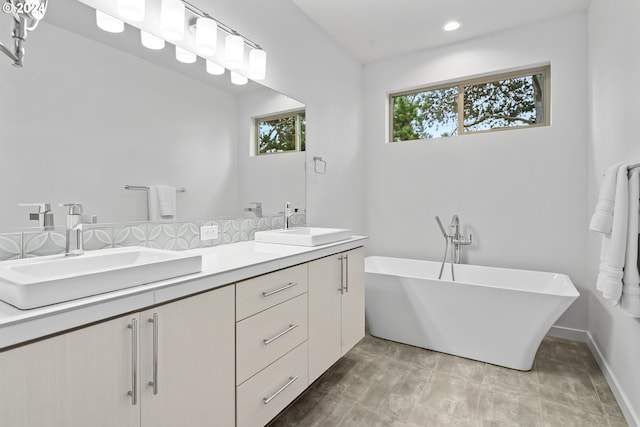 bathroom featuring vanity and a washtub