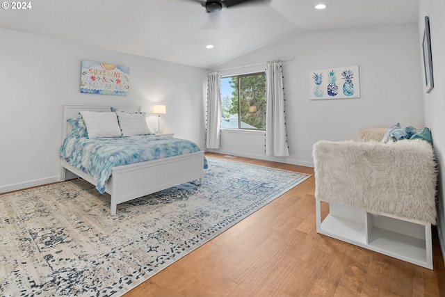 bedroom with hardwood / wood-style flooring and lofted ceiling