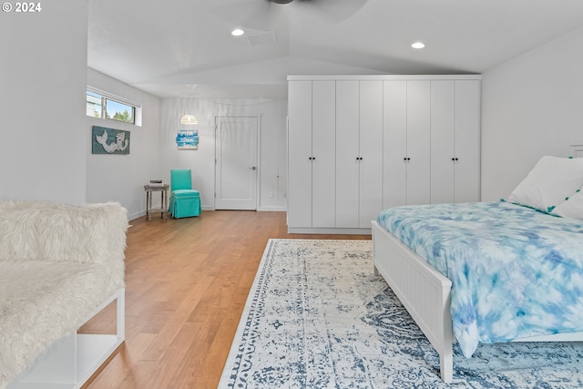 bedroom with lofted ceiling, light wood-type flooring, and ceiling fan