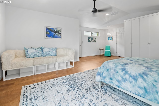 bedroom featuring wood-type flooring, vaulted ceiling, and ceiling fan