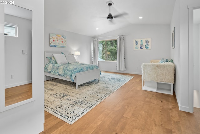 bedroom featuring ceiling fan, hardwood / wood-style flooring, and lofted ceiling