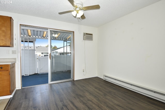 unfurnished room with a wall mounted AC, a textured ceiling, dark hardwood / wood-style floors, baseboard heating, and ceiling fan