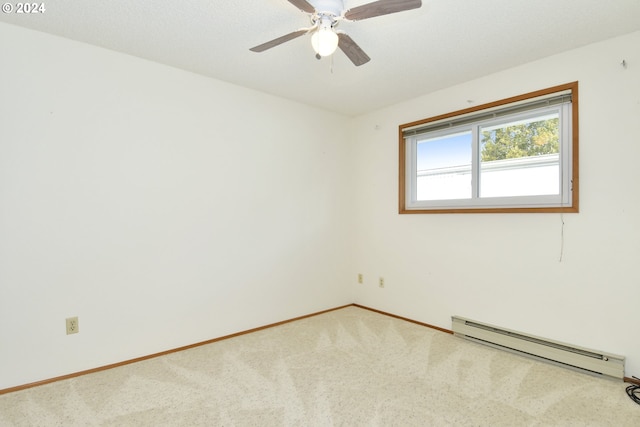 spare room featuring ceiling fan, carpet floors, and a baseboard radiator