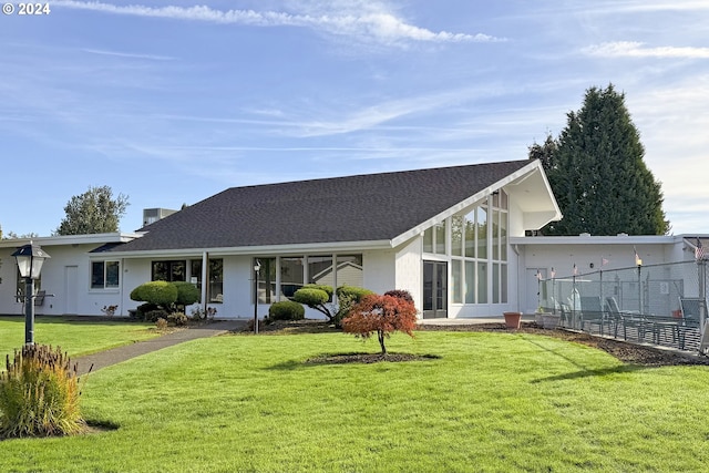 back of house featuring a sunroom and a yard