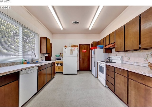 kitchen featuring sink and white appliances