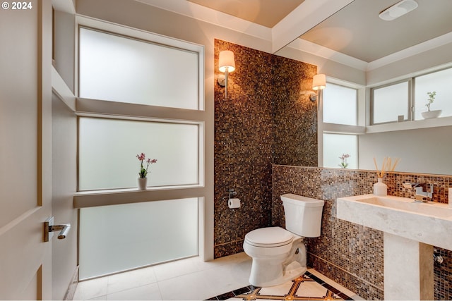 bathroom with backsplash, tile patterned floors, and toilet