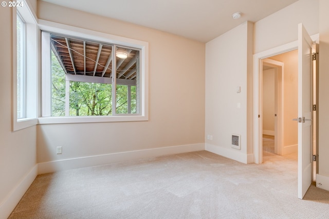 unfurnished room with light carpet