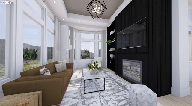 interior space featuring a tray ceiling, light hardwood / wood-style flooring, and a notable chandelier