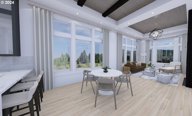 dining space with beam ceiling, light hardwood / wood-style flooring, a tray ceiling, and wood ceiling