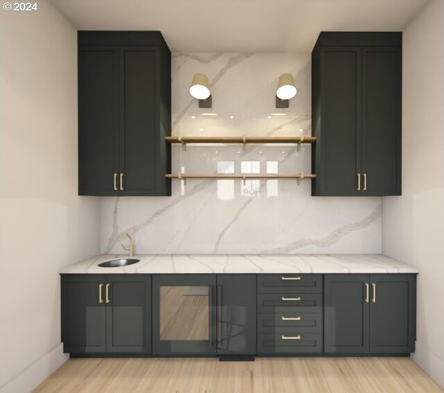 bar featuring sink, light hardwood / wood-style flooring, and light stone counters