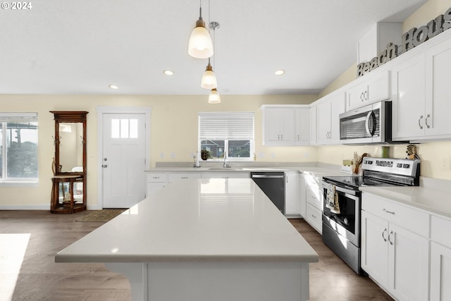 kitchen featuring a wealth of natural light, a center island, and appliances with stainless steel finishes