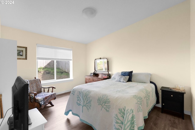 bedroom with dark hardwood / wood-style flooring